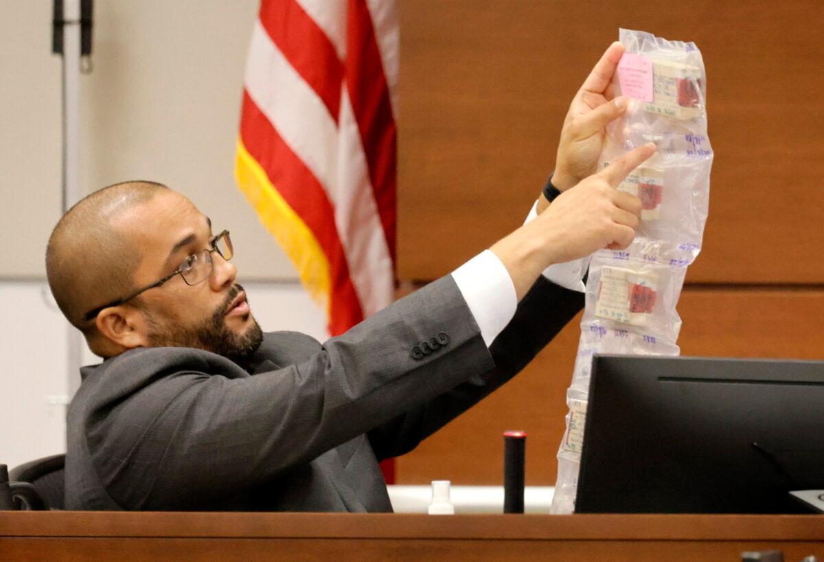 BSO crime scene detective Miguel Suarez points to bullet casings collected at the scene of the shooting as he testifies in the penalty phase of Marjory Stoneman Douglas High School shooter Nikolas Cruz's trial at the Broward County Courthouse in Fort Lauderdale, Fla., on July 25, 2022. (Carline Jean/South Florida Sun-Sentinel via AP, Pool)