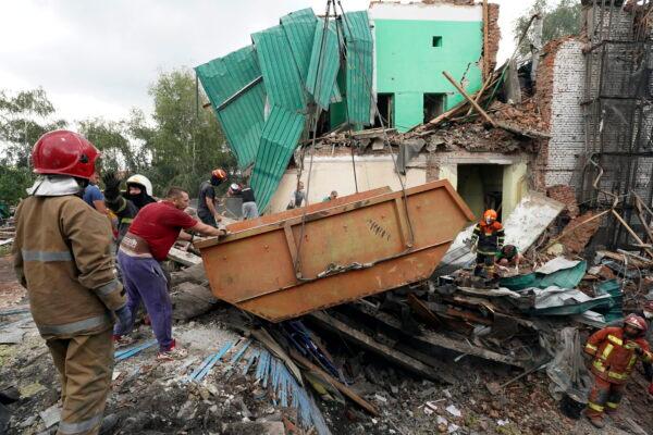 Rescuers remove debris after a Russian missile attack on Monday in Chuhuiv, Kharkiv region, Ukraine, on July 26, 2022. (Andrii Marienko/AP Photo)