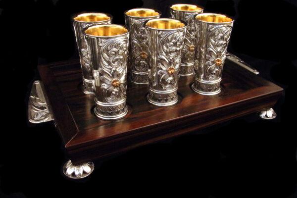 Set of six shot glasses, 2019, by Scott Hardy. Sterling silver, lined with 18-karat gold; decorated with sterling silver scroll and flower overlays, with 14-karat gold flower centers. (Leslie Hardy)
