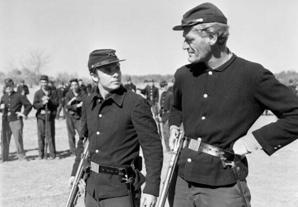 Henry Fleming (Audie Murphy, L) talks to friend Jim Conklin (John Dierkes) about their upcoming battle, in “The Red Badge of Courage.” (Metro-Goldwyn-Mayer)