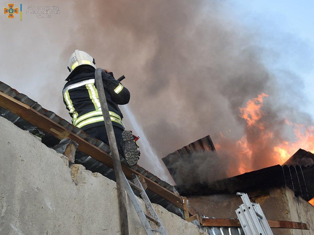A firefighter works to douse a fire in a building in Mykolaiv, in this handout picture released on July 31, 2022. (State Emergency Service of Ukraine in Mykolaiv Region/Handout via Reuters)