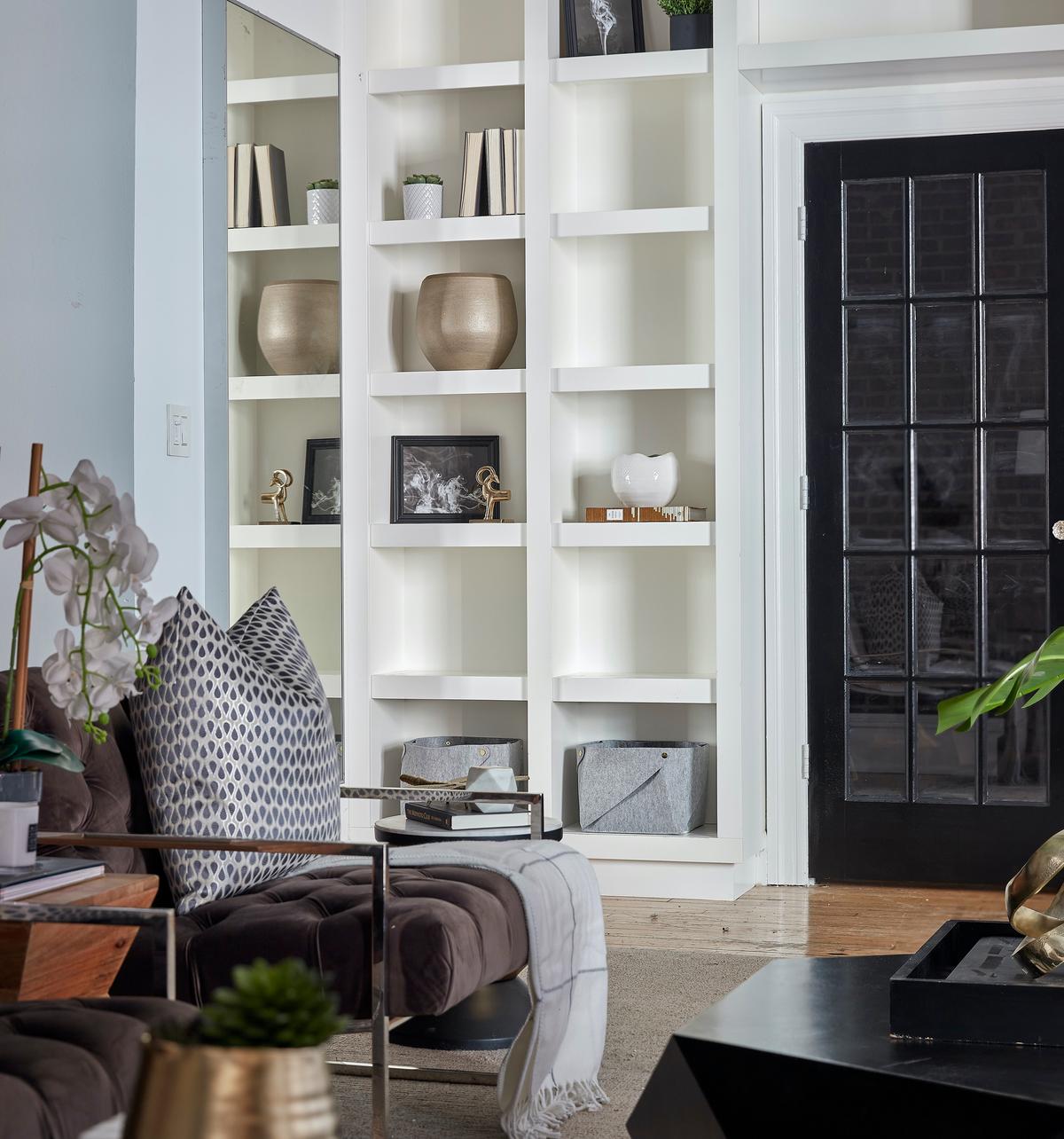A living room bookcase is dressed with a mix of bins, vases, books, framed images and accents. (Scott Morris/Cathy Hobbs/TNS)