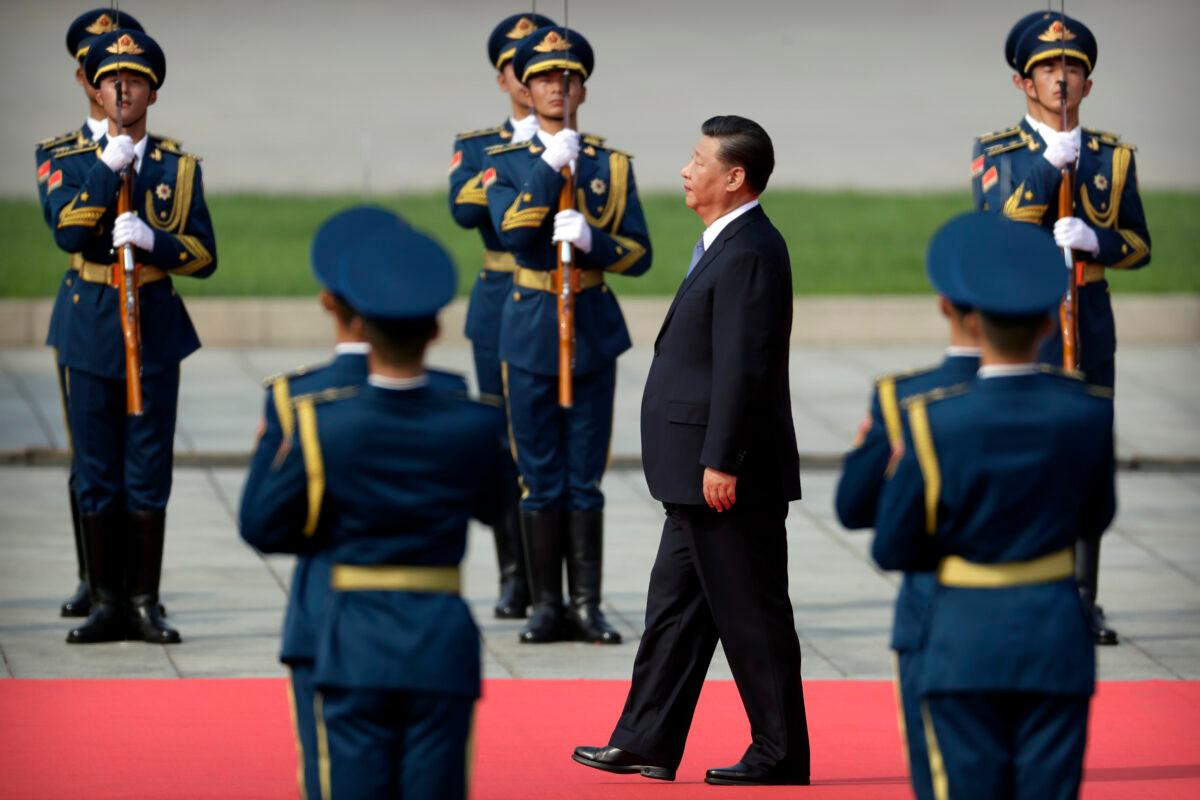 Chinese Communist Party leader Xi Jinping walks past an honor guard as he approaches the Monument to the People's Hereos during a ceremony to mark Martyr's Day at Tiananmen Square in Beijing, on Sept. 30, 2019. (Mark Schiefelbein-Pool/Getty Images)