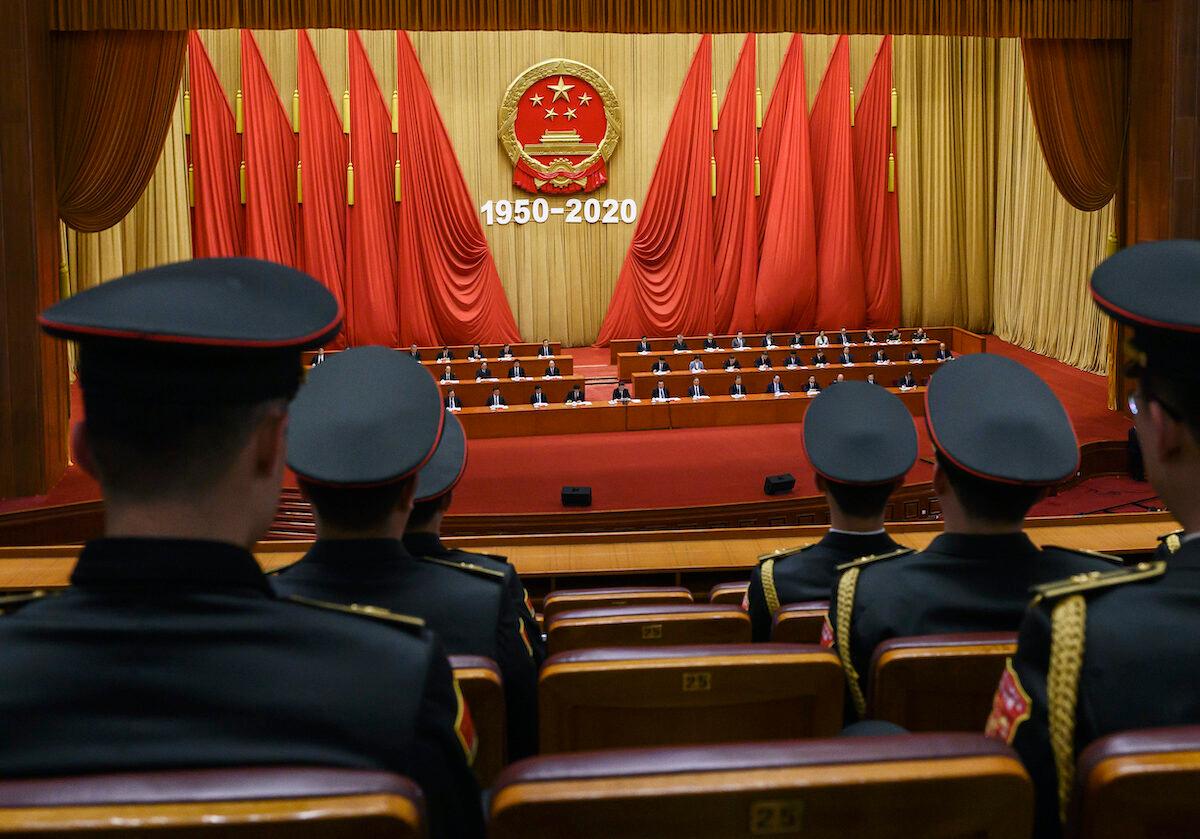 People's Liberation Army band members watch as  Xi Jinping, middle, and senior members attend a ceremony marking the 70th anniversary of China's entry into the Korean War, on October 23, 2020, in Beijing, China. (Kevin Frayer/Getty Images)