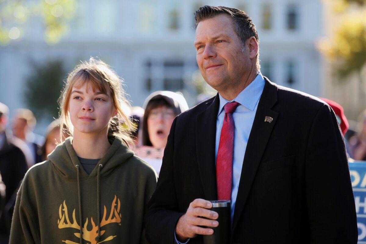 Former Kansas Secretary of State Kris Kobach with his oldest daughter outside the Kansas Statehouse in Topeka, on Oct. 30, 2021. (John Hanna/AP Photo)