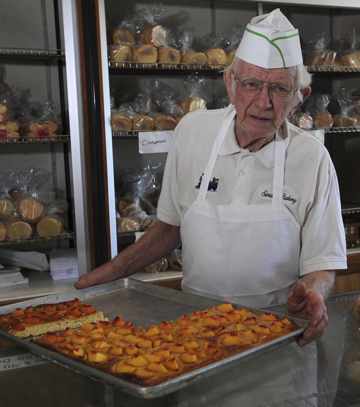 On July 29, 2014, the late George Simon made his peach cake at his bakery, Simon's Bakery, in the Cranbrook Shopping Center in Cockeysville. (Karen Jackson)