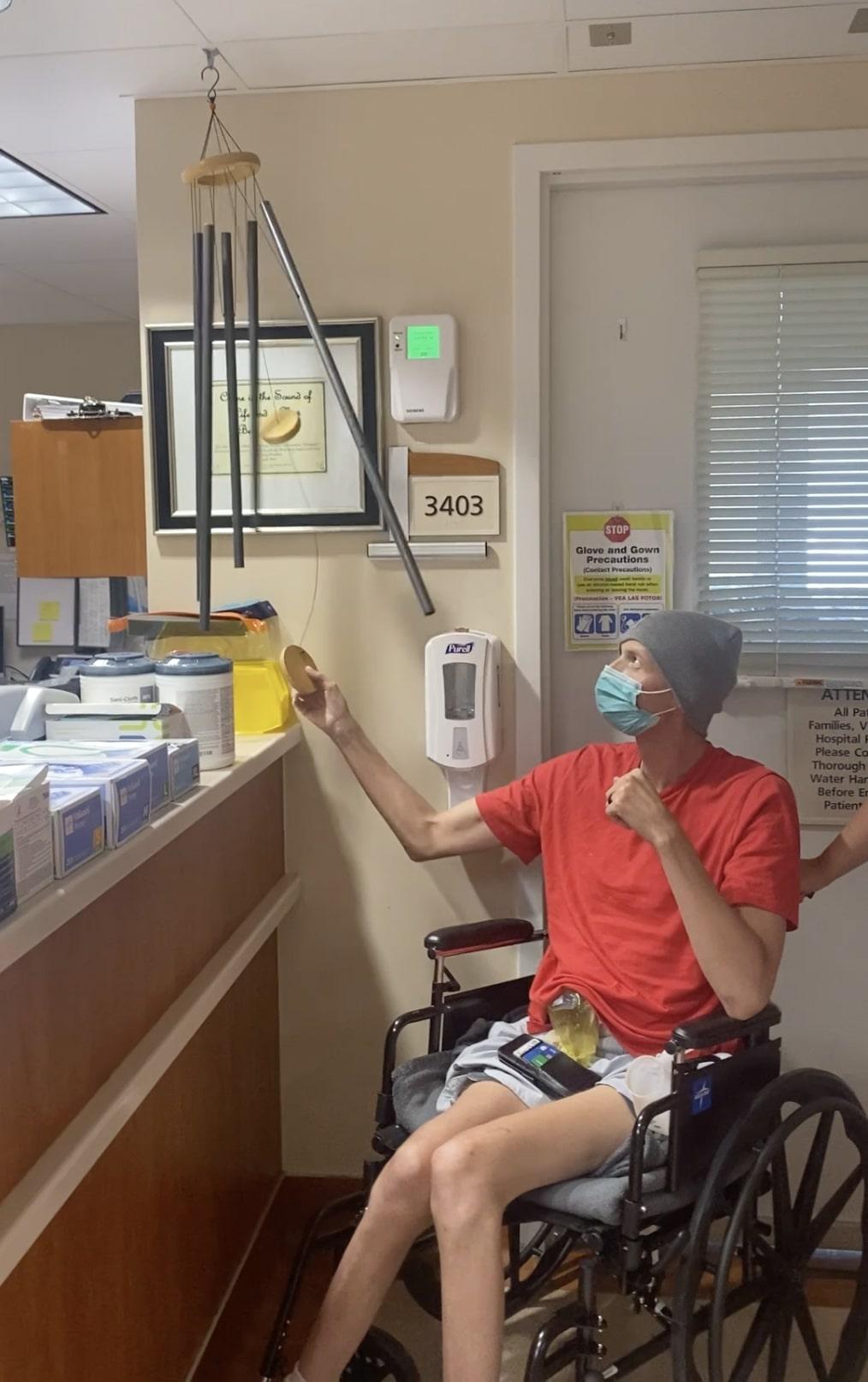 Zach rings the bell after being declared cancer-free. (Courtesy of Madison Stroup)