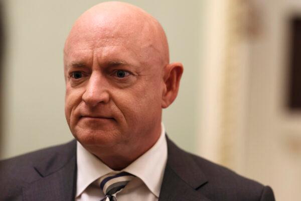 Sen. Mark Kelly (D-Ariz.) speaks with a journalist before going to a luncheon with Senate Democrats in Washington, on June 14, 2022. (Anna Moneymaker/Getty Images)