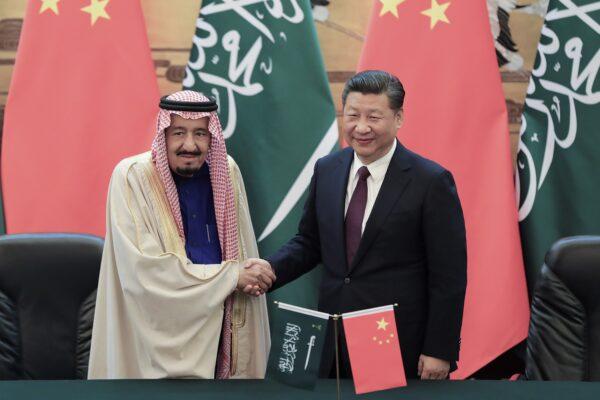 Chinese leader Xi Jinping shakes hands with Saudi Arabia's King Salman bin Abdulaziz Al Saud during a signing ceremony at the Great Hall of the People in Beijing on Mar. 16, 2017. (Lintao Zhang/Pool/Getty Images)