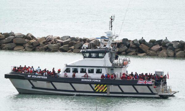 A group of people onboard a Border Force vessel and thought to be illegal immigrants are brought into Ramsgate, Kent, on Aug. 1, 2022. (Gareth Fuller/PA Media)