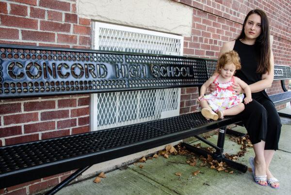 Unvaccinated English and special education teacher, Rachel Maniscalco, and her daughter Julia, in front of her former place of employment, Concord High School in Staten Island, New York, on Aug. 2, 2022. (Dave Paone/The Epoch Times)
