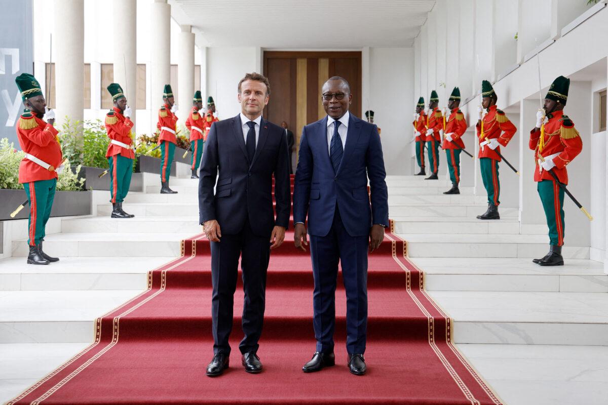 French president Emmanuel Macron (L) poses with Beninese president Patrice Talon (R) during an official visit to the Presidential Palace in Cotonou on July 27, 2022. (Ludovic Marin/AFP via Getty Images)