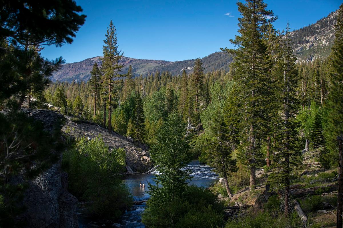 A couple relax in the solitude of the cool waters of the Middle Fork San Joaquin River near the Rainbow Falls National Monument on June 21, 2022. (Allen J. Schaben Los Angeles Times/TNS)