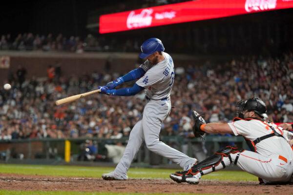 Los Angeles Dodgers' Cody Bellinger hits an RBI triple in front of San Francisco Giants catcher Joey Bart, right, during the eighth inning of a baseball game in San Francisco, Tuesday, Aug. 2, 2022. (Jeff Chiu/AP Photo)