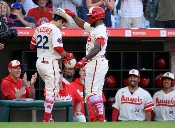 Luis Rengifo #2 of the Los Angeles Angels puts a cowboy hat on David Fletcher #22 after he hit a home run in the first inning against the Oakland Athletics at Angel Stadium of Anaheim, in Anaheim, August 2, 2022. (John McCoy/Getty Images)