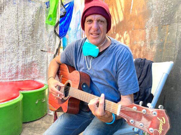 Mario Fase, who goes by the nickname "Guitar Man," has been homeless on Skid Row since his divorce 10 years ago. (Allan Stein/The Epoch Times)