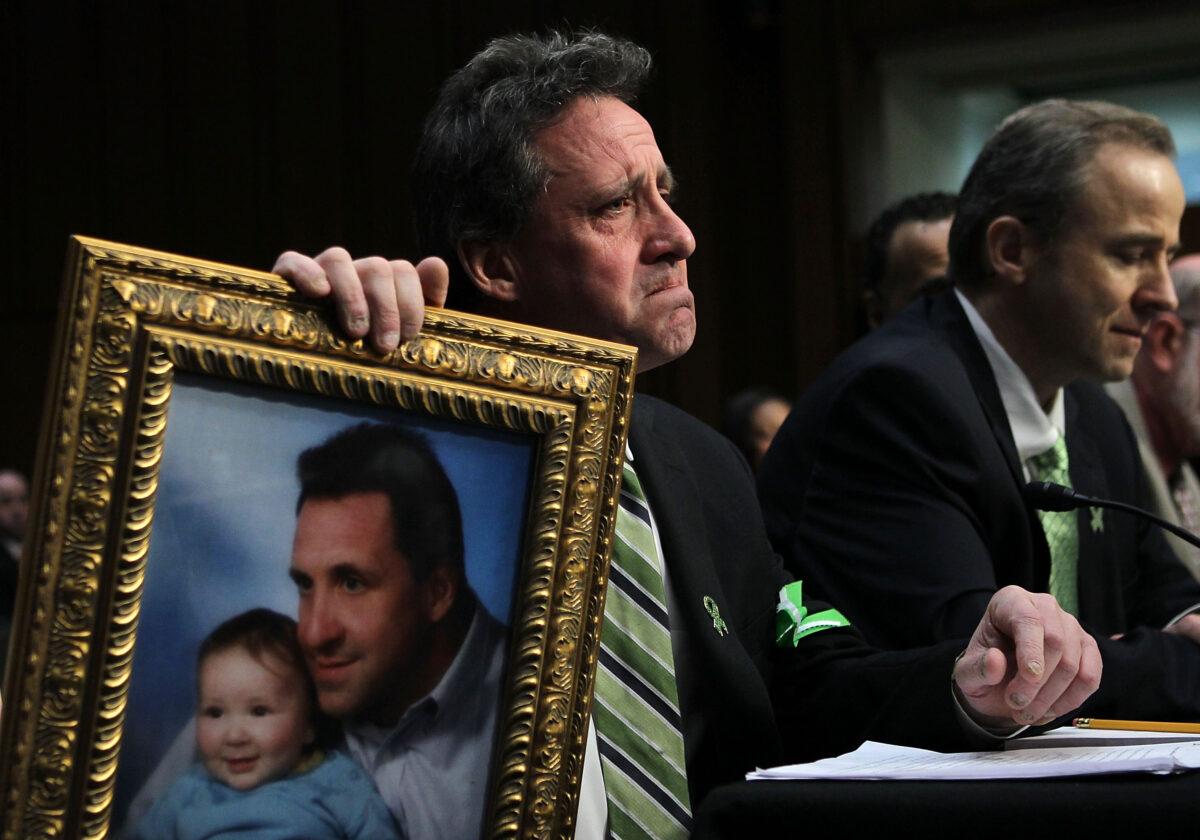 Neil Heslin, father of 6-year-old Sandy Hook Elementary School shooting victim Jesse Lewis, holds a picture of him with Jesse during a hearing in Washington in a file image. (Alex Wong/Getty Images)