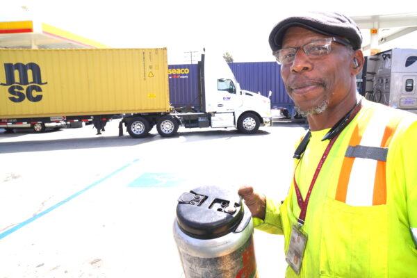 Independent truck owner-operator Titus Jones makes his way back to his semi outside a truck stop in Long Beach, Calif., on July 26, 2022. Jones said he supports California's new labor law as a way to eliminate wage and tax cheating. (Allan Stein/The Epoch Times)
