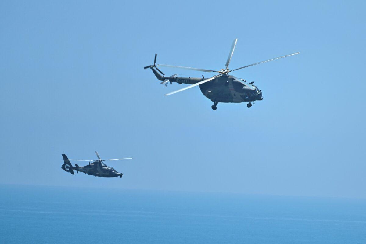 Chinese military helicopters fly past Pingtan island, one of mainland China's closest points from Taiwan, in Fujian Province, ahead of military drills off Taiwan, on Aug. 4, 2022. (Hector Retamal/AFP via Getty Images)