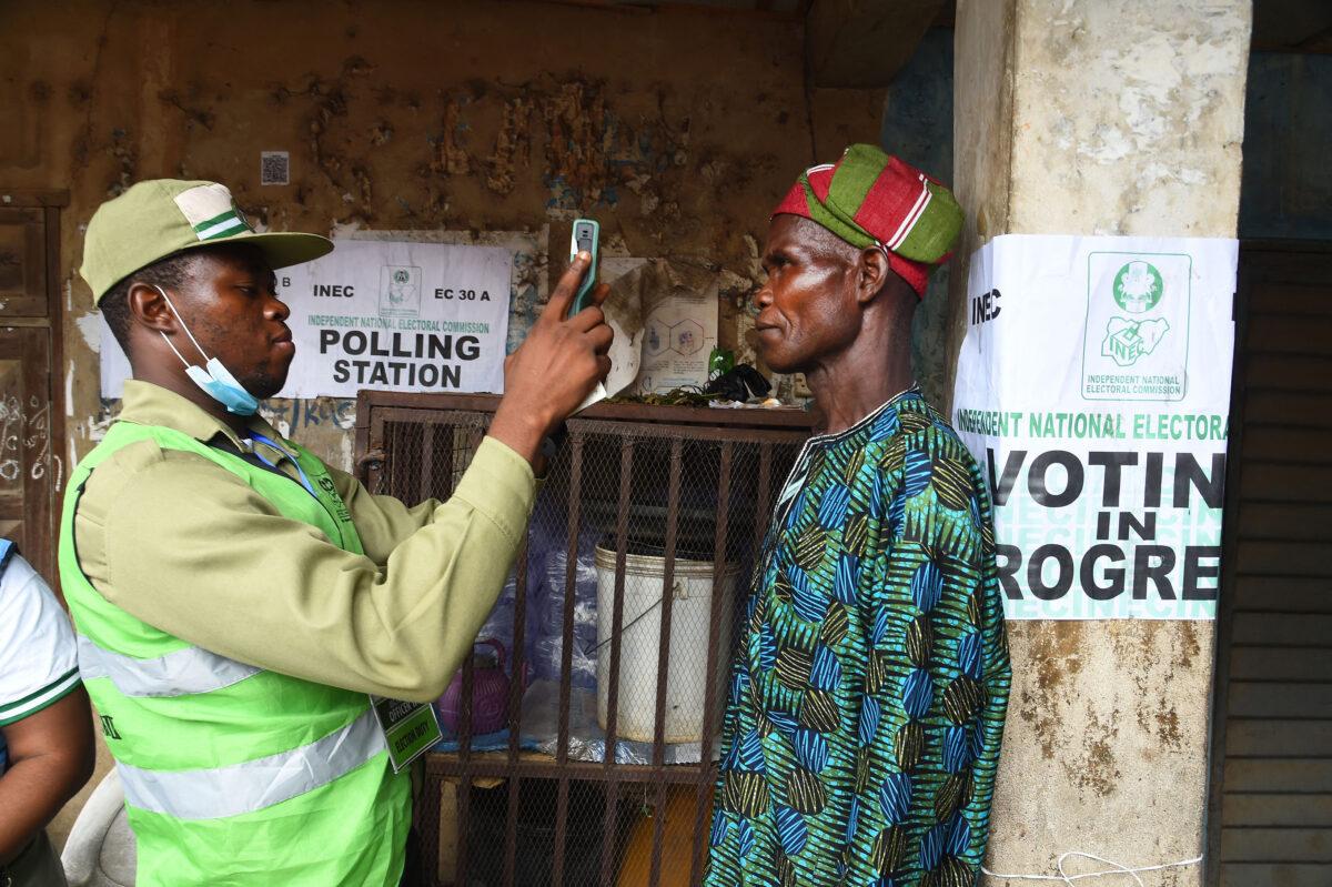 An official of the Independent National Electoral Commission validates a voter at a polling station during the gubernatorial election at Ede in Osun state, southwest Nigeria, on July 16, 2022. (Pius Utomi Ekpei/AFP via Getty Images)