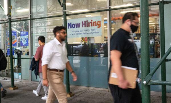 A "now hiring" sign is displayed in a window in Manhattan on July 28, 2022. (Spencer Platt/Getty Images)