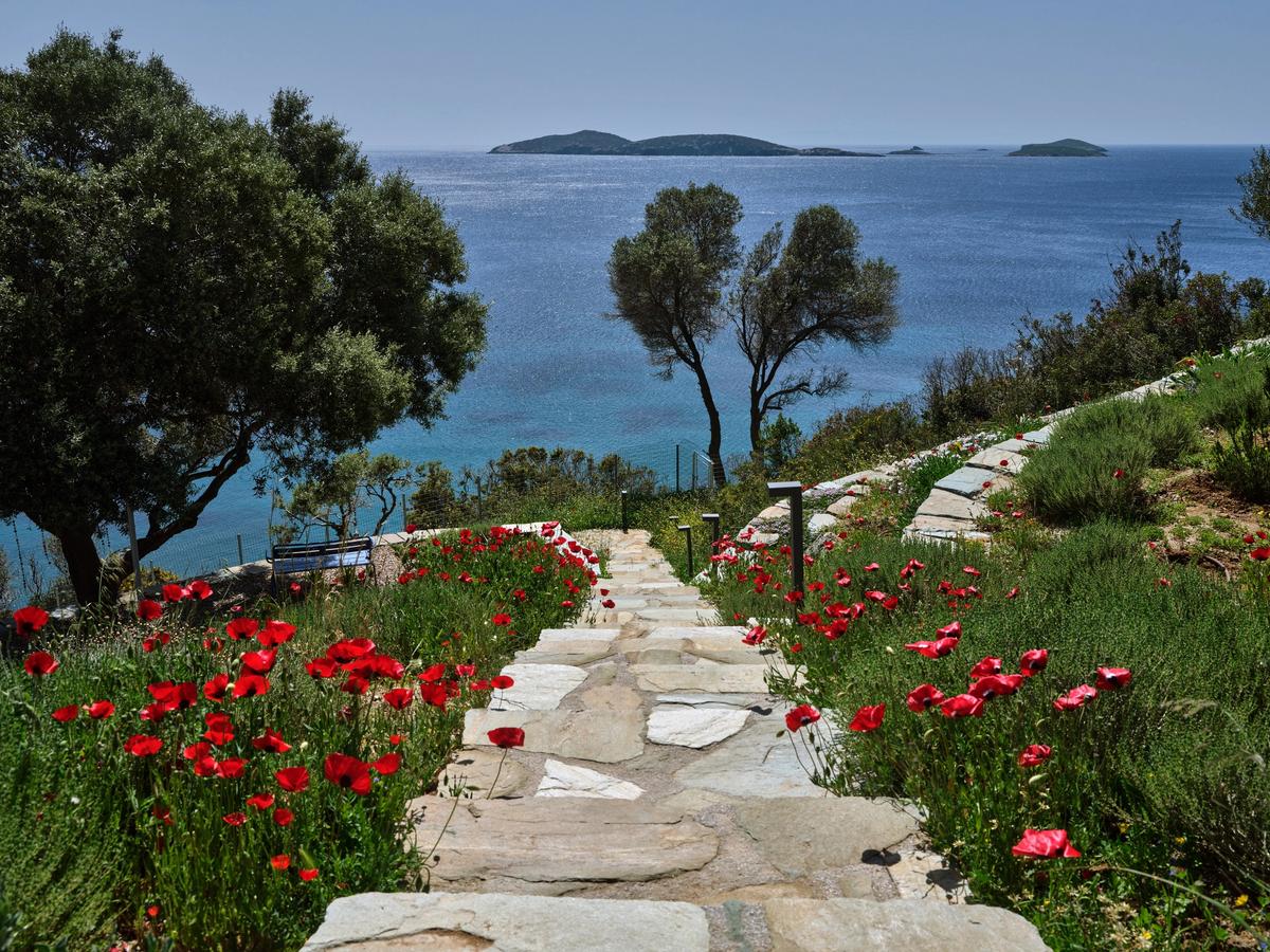 The path to the private beach has several stop-off spots ideal for reading a bestseller, or just gazing at the shimmering sea. (Courtesy of Greece Sotheby's International Realty)