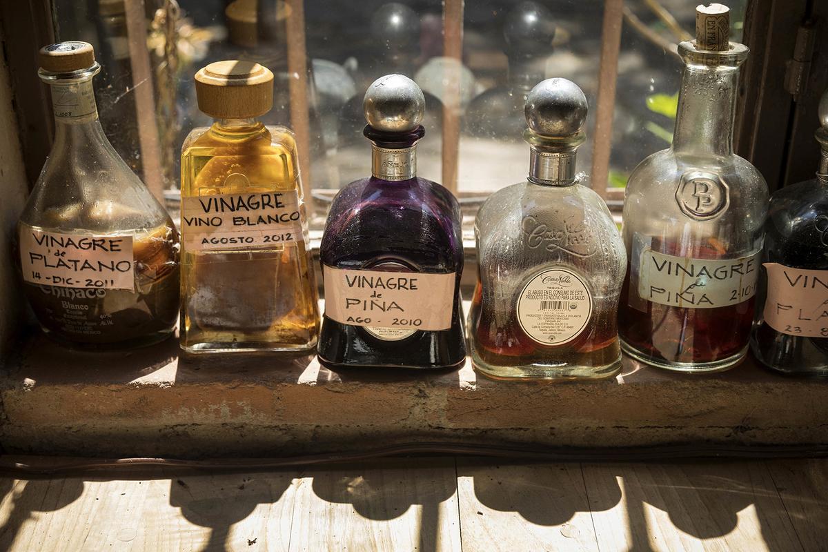 A variety of homemade vinegars on the kitchen window sill at Quinta Diana. (Ricardo DeAratanha/Los Angeles Times/TNS)