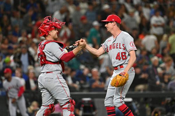 Max Stassi #33 and Jimmy Herget #46 of the Los Angeles Angels shake hands after the game against the Seattle Mariners at T-Mobile Park in Seattle, Washington, on August 5, 2022. (Alika Jenner/Getty Images)