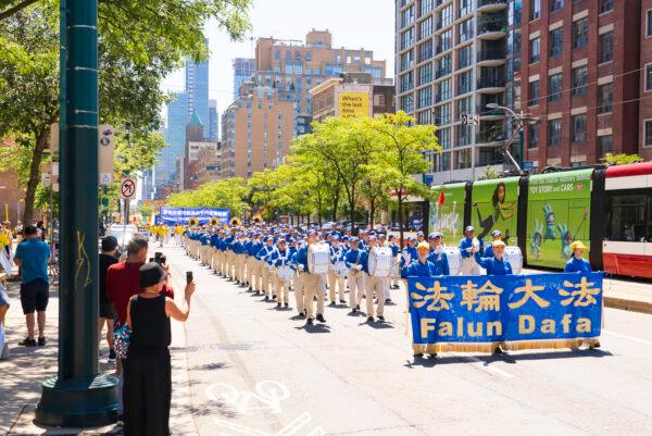 The Tian Guo Marching Band takes part in a parade in downtown Toronto to celebrate 400 million Chinese people quitting the Chinese Communist Party and its affiliated organizations, on Aug. 6, 2022. (Evan Ning/The Epoch Times)