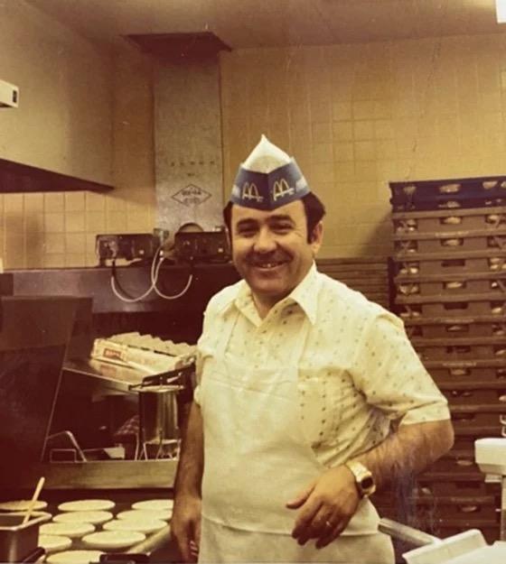 Tony Philiou stands near cooking hamburgers during the early days of his six-decade career with the McDonald's. He now owns the restaurant. (Courtesy of Tony Philiou)