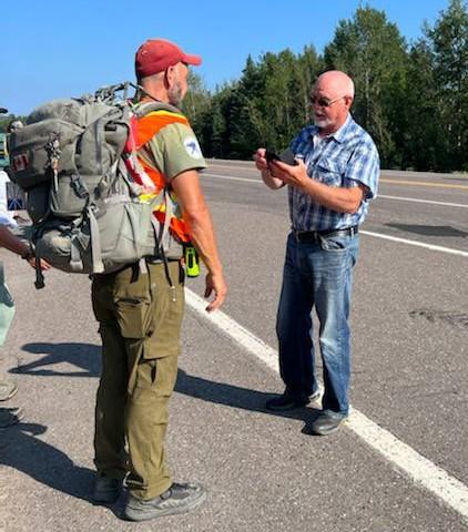 James Topp talks to a supporter in Newfoundland and Labrador as he continues the second phase of his cross-country trek to protest mandatory COVID-19 vaccine mandates. (Courtesy Dana Metcalfe)