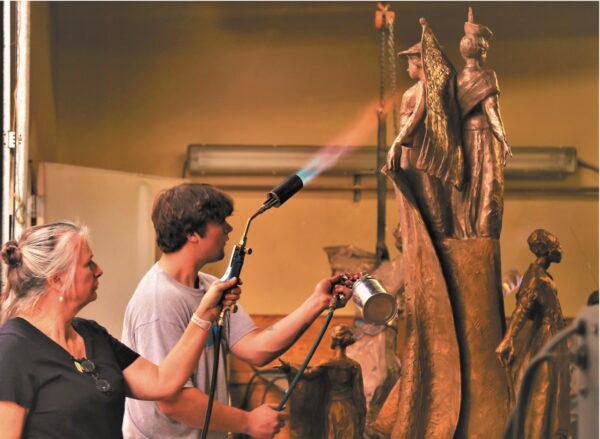 DeDecker and her son, David, work on one of her statues. (Poppy Richie for American Essence)