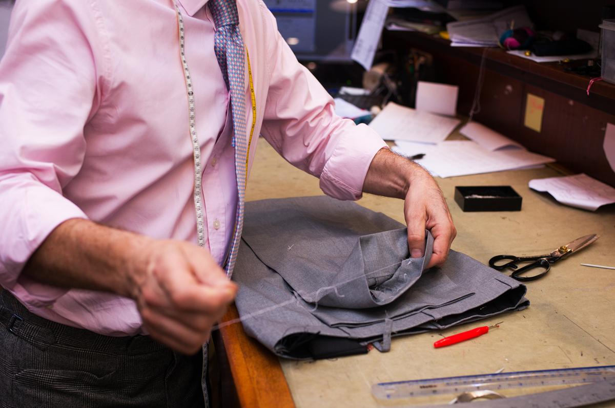 Alex Cooke sews trousers for a customer, Henry Poole & Co. of Savile Row. (Alan Behr/TNS)