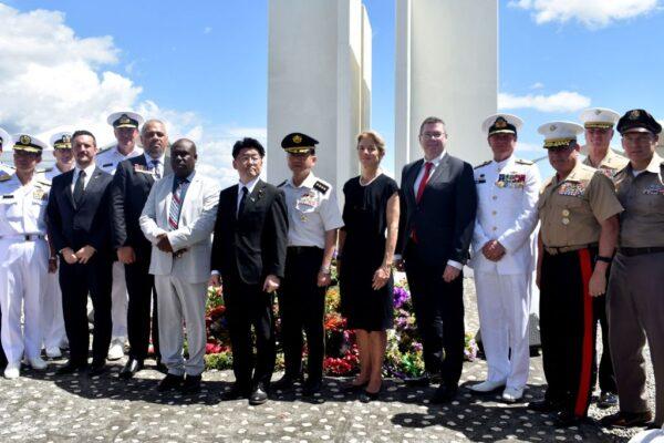 Japan's Defense Minister Makoto Oniki (5th L), Japan's Chief of Staff, Joint Staff General Koji Yamazaki (C), posing for pictures with U.S. Ambassador to Australia Caroline Kennedy (5th R) and Australian Minister for International Development and the Pacific and the Minister for Defense Industry Pat Conroy (4th R) during a ceremony marking the 80th anniversary of the Battle of Guadalcanal at Skyline Ridge in Honiara on the Solomon Islands, on Aug. 7, 2022. (Charley Pringi/AFP via Getty Images)