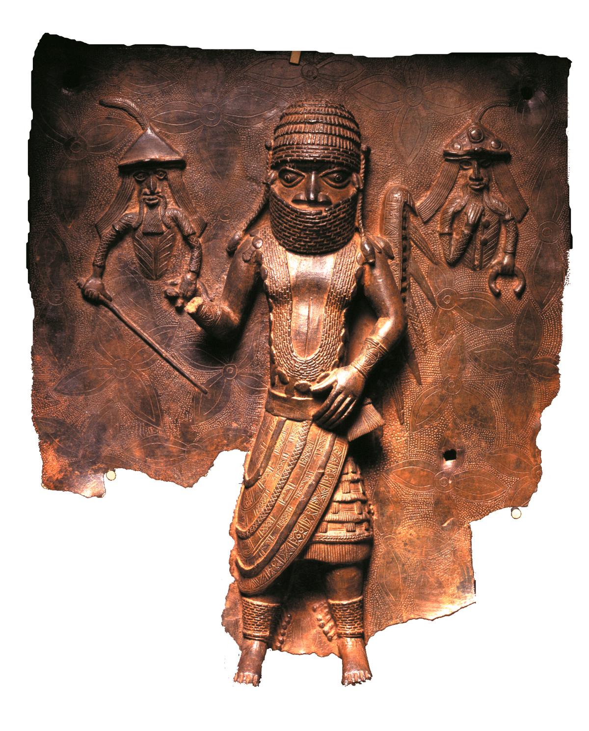 A Benin copper alloy plaque representing an encounter between Benin Chief Uwangue and Portuguese traders, who are depicted to his left and right. (Courtesy of Horniman Museum and Gardens via AP)