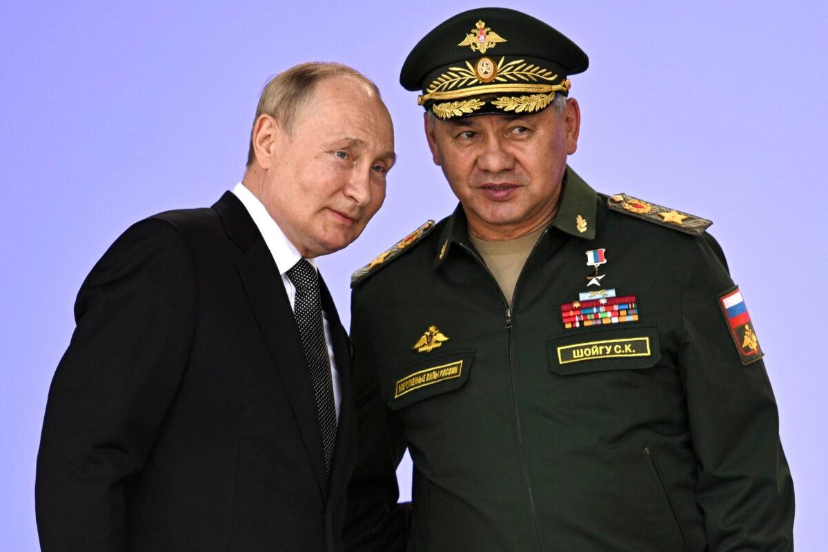 Russian President Vladimir Putin and Russian Defense Minister Sergei Shoigu attend the opening of the Army 2022 International Military and Technical Forum in the Patriot Park outside Moscow, on Aug. 15, 2022. (Sputnik/Kremlin Pool Photo via AP)