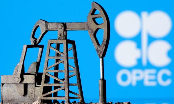 A 3D-printed oil pump jack is seen in front of the OPEC logo in this illustration picture, on April 14, 2020. (Dado Ruvic/Reuters)