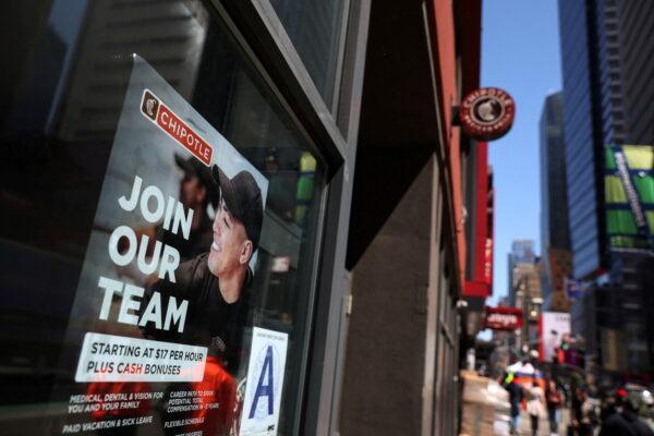 A sign for hire is posted on the window of a Chipotle restaurant in New York on April 29, 2022. (Shannon Stapleton/File Photo/Reuters)