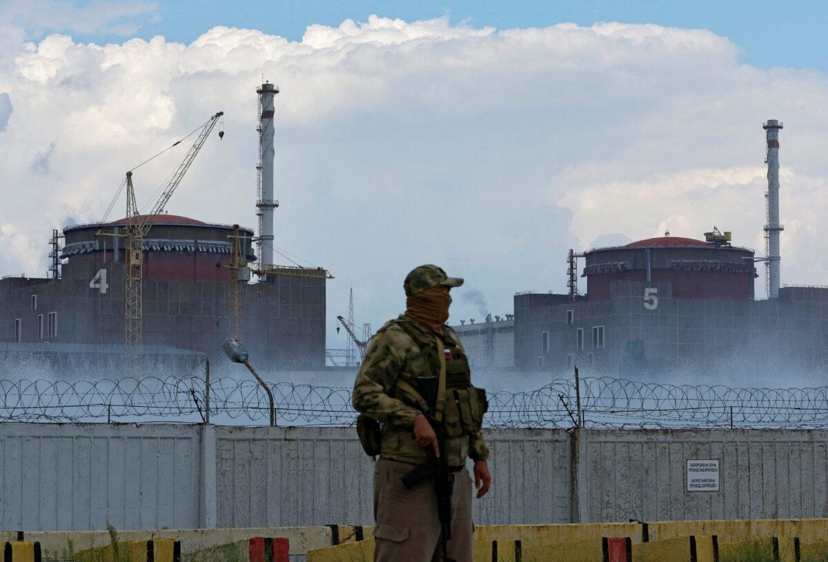 A serviceman with a Russian flag on his uniform stands guard at the Zaporizhzhia Nuclear Power Plant in Enerhodar, Ukraine, on Aug. 4, 2022. (Alexander Ermochenko/Reuters)