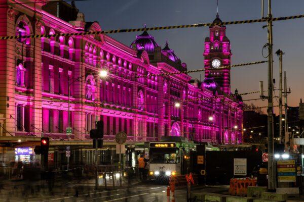Melbourne's historical Flinders Street Station is lit up pink as a tribute to Olivia Newton-John, in Melbourne, Australia, on Aug. 9, 2022. Olivia Newton-John, the singing superstar who won viewers' hearts as Sandy in the blockbuster musical Grease, has died aged 73 at her home in California. (AAP Image/Diego Fedele)
