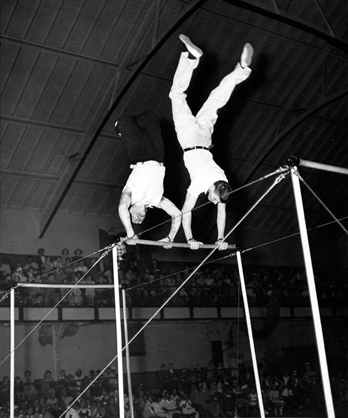 Photograph of Nick Cravat and Burt Lancaster, performing on the horizontal bars as Lang & Cravat with the Federal Theatre Project Circus between 1935 and 1938. (Public Domain)