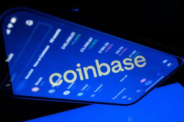 A flipped version of the Coinbase logo is reflected on a mobile phone screen in London on Nov. 9, 2021, in a photo illustration. (Leon Neal/Illustration/Getty Images)