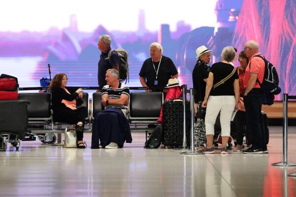 Passengers wait at the Qantas check in at Sydney International Airport in Sydney, Australia, on March 19, 2020. (Mark Metcalfe/Getty Images)