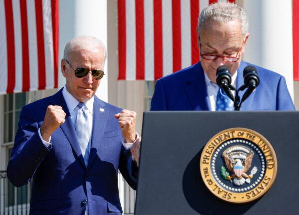 President Joe Biden reacts as Senate Majority Leader Chuck Schumer (D-N.Y.) speaks before Biden signs the CHIPS and Science Act of 2022 during a ceremony on the South Lawn of the White House in Washington on Aug. 9, 2022. (Chip Somodevilla/Getty Images)