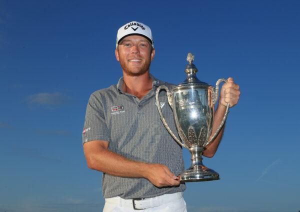 Talor Gooch of the United States celebrates with the trophy on the 18th green after winning during the final round of The RSM Classic on the Seaside Course at Sea Island Resort in St. Simons Island, Georgia, on November 21, 2021. (Sam Greenwood/Getty Images)