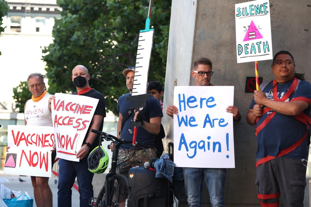 Health care and LGBT activists hold signs as they stage a protest outside of the San Francisco Federal Building in San Francisco on Aug. 8, 2022. (Justin Sullivan/Getty Images)