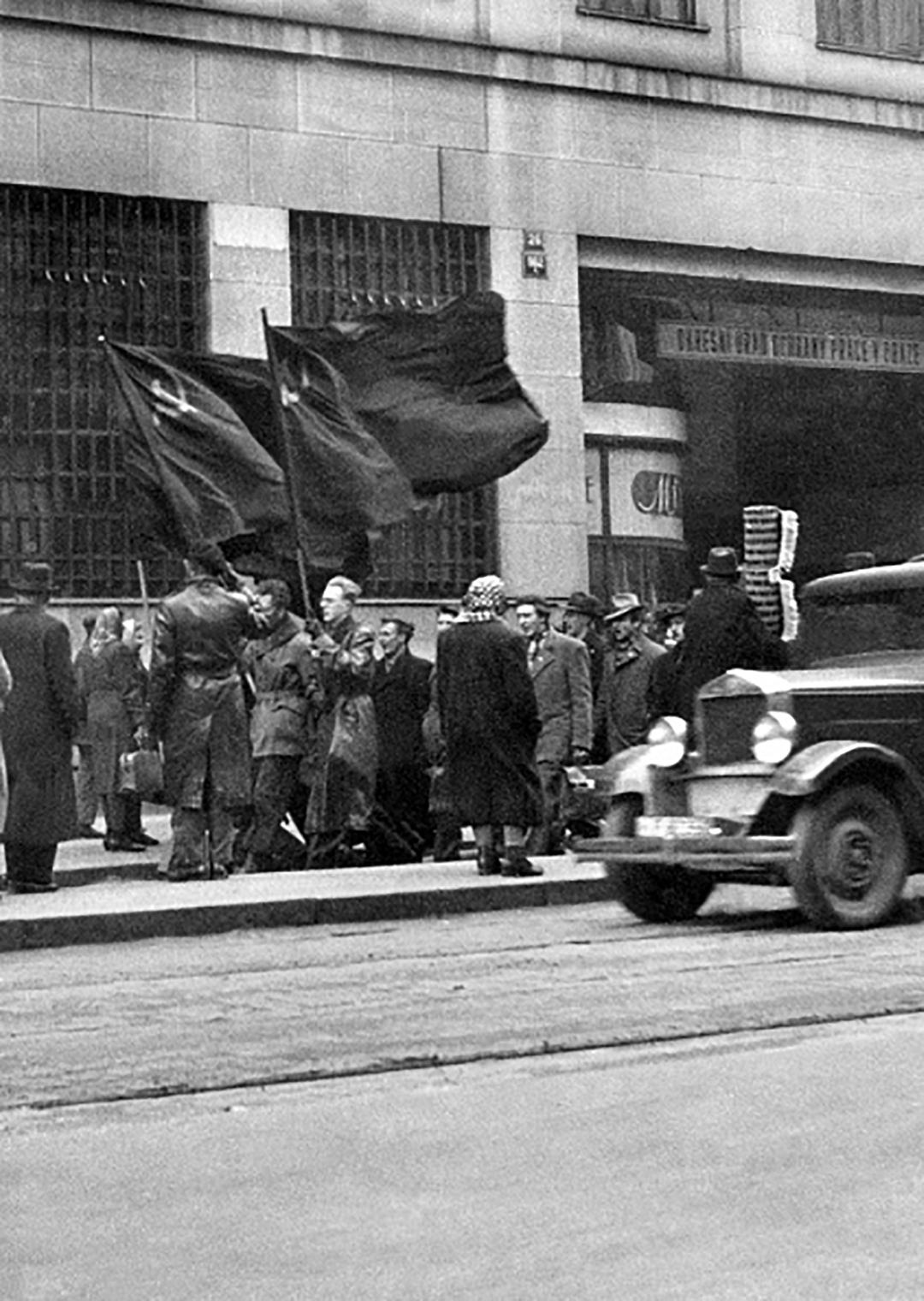Czechoslovakian Communist Party activists carry red hammer and sickle flags to a rally in downtown Prague on Feb. 28, 1948. Communists called the rally to prove their victory in the political coup d'etat which brought them to power for more than 41 years. ( STR/ACME/AFP via Getty Images)