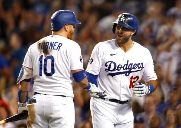 Joey Gallo #12 of the Los Angeles Dodgers celebrates with Justin Turner #10 after hitting a three-run home run against the Minnesota Twins in the seventh inning at Dodger Stadium in Los Angeles, on August 10, 2022. (Ronald Martinez/Getty Images)