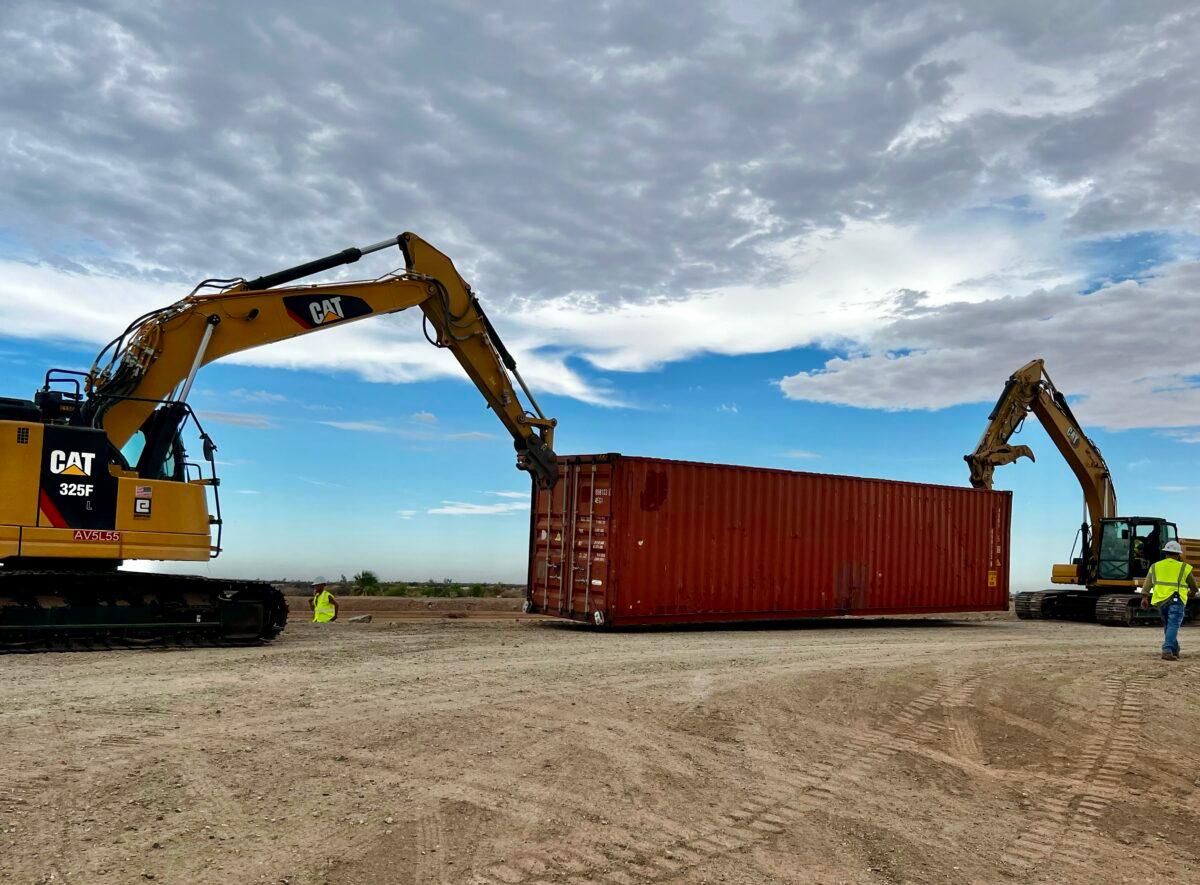 Contractors begin stacking shipping containers in border fence gaps near Yuma, Ariz., on Aug. 12, 2022. (Courtesy of Arizona Governor’s office)