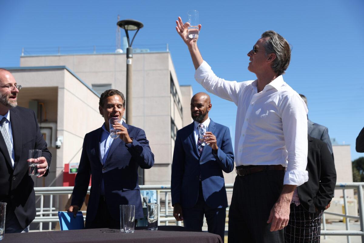 California Gov. Gavin Newsom (R) prepares to taste wastewater that was treated at the Antioch Water Treatment Plant with former Los Angeles Mayor Antonio Villaraigosa (L) and Antioch Mayor Lamar Thorpe (C) in Antioch, Calif., on Aug. 11, 2022. (Justin Sullivan/Getty Images)